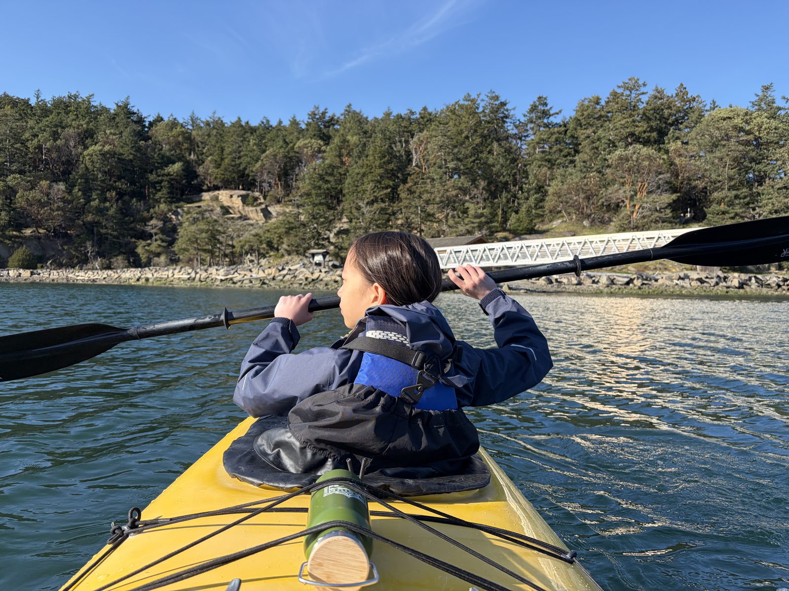A student kayaking on the water during April Adventures