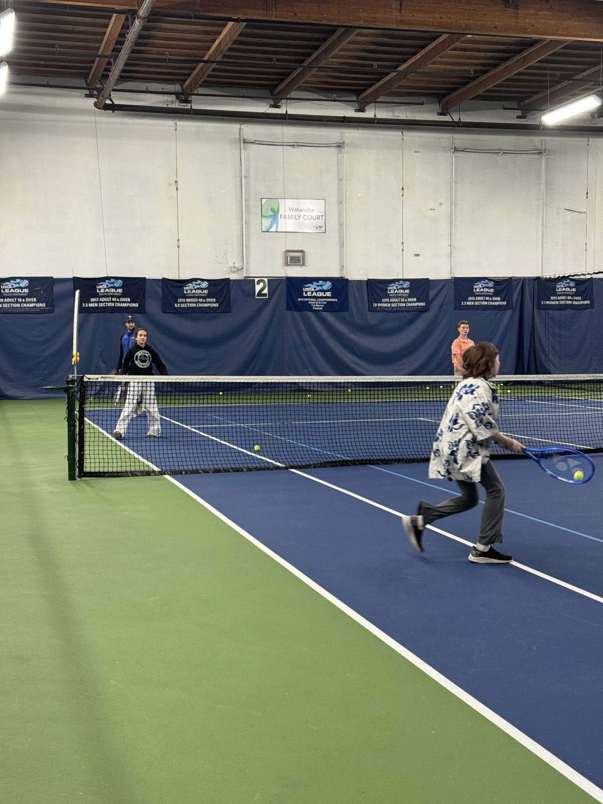 A student playing tennis