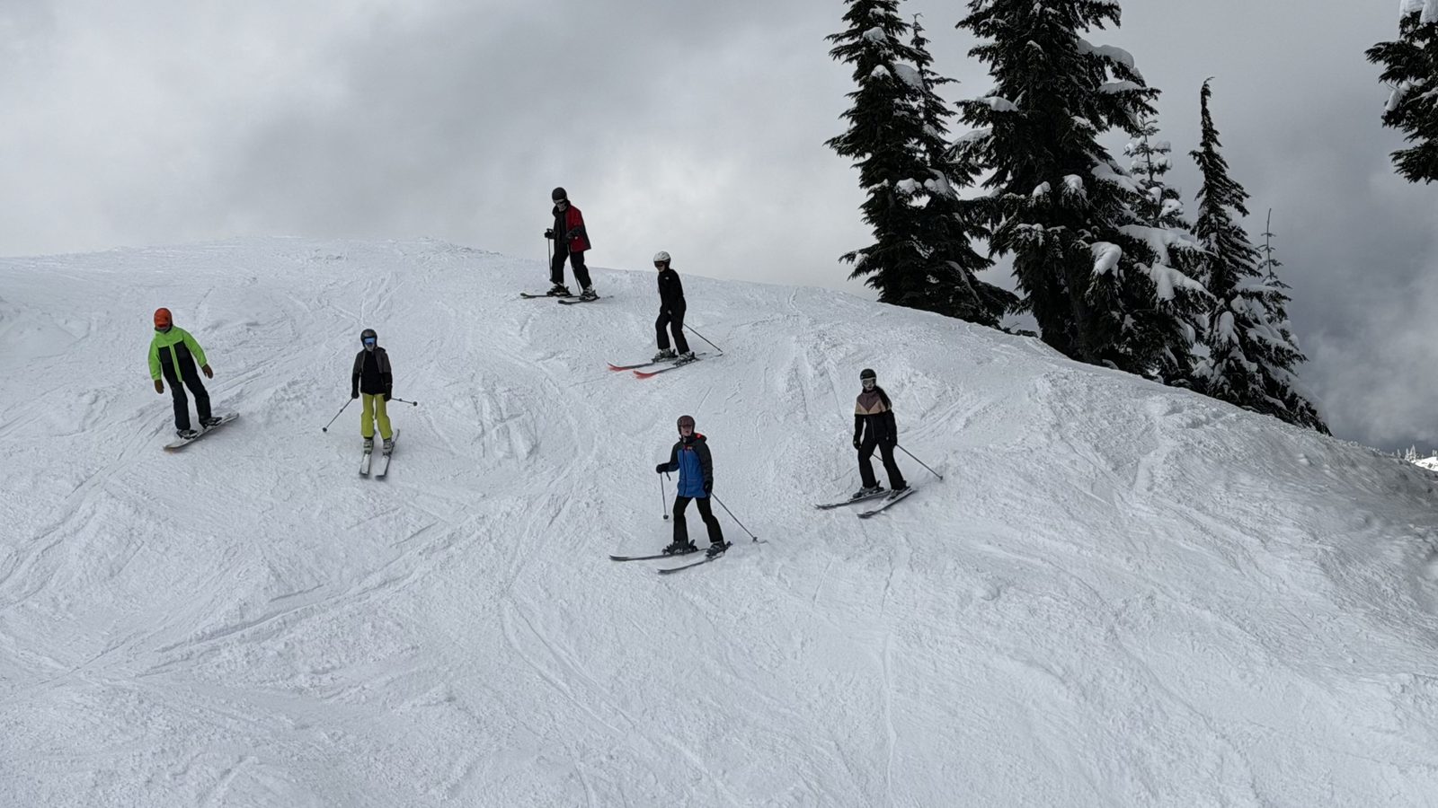 Students skiing on a mountain slope