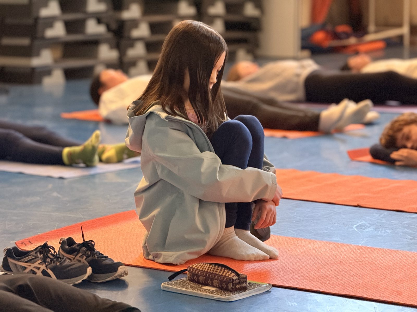 Students relaxing during a mindfulness and yoga session